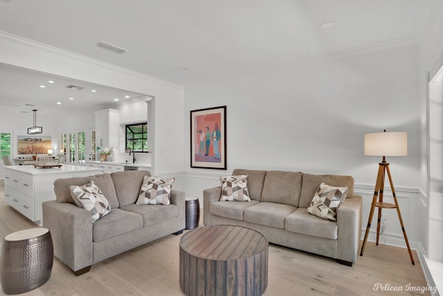 314 Gentilly Cir, Shreveport, LA 71106 - living area with crown molding, light wood finished floors, a wainscoted wall, and visible vents