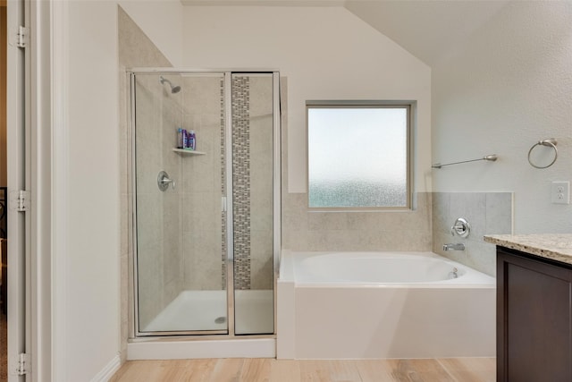 full bathroom with vanity, wood finished floors, a bath, and a shower stall