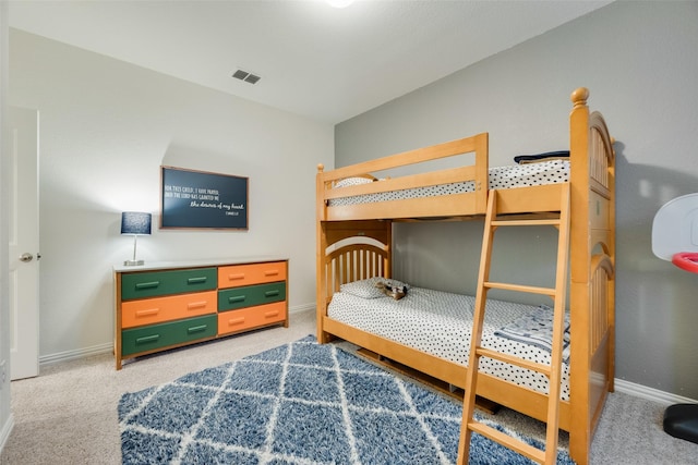 bedroom with baseboards, visible vents, and light carpet
