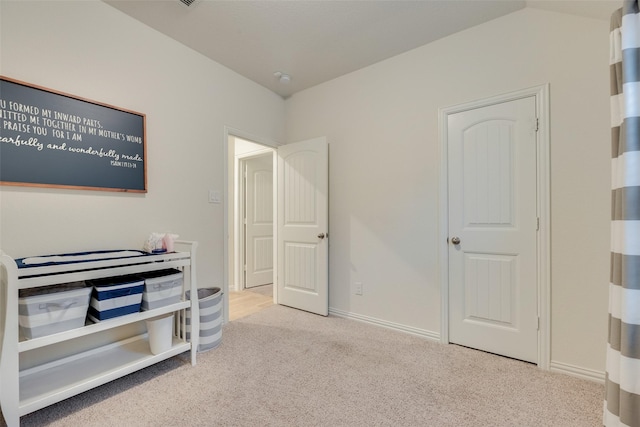 carpeted bedroom featuring baseboards