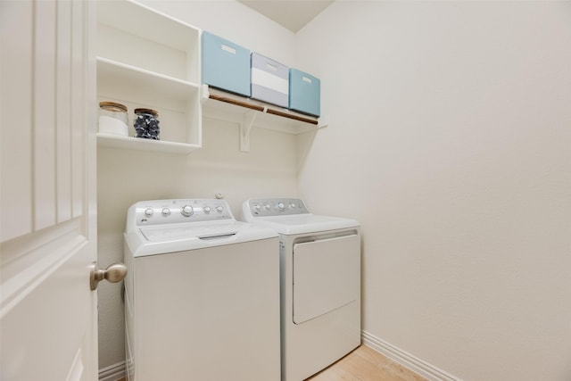 washroom with laundry area, baseboards, independent washer and dryer, and light wood-style floors