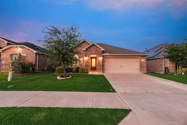 ranch-style home with concrete driveway, brick siding, a lawn, and a garage