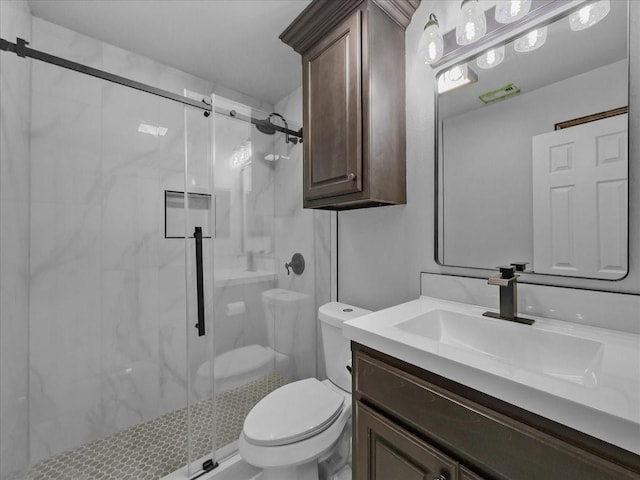 bathroom with vanity, toilet, and a stall shower