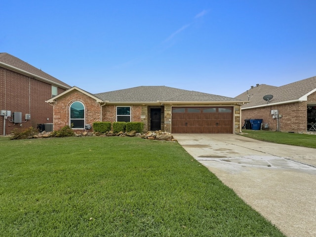 ranch-style home with a garage, central air condition unit, a front yard, and concrete driveway