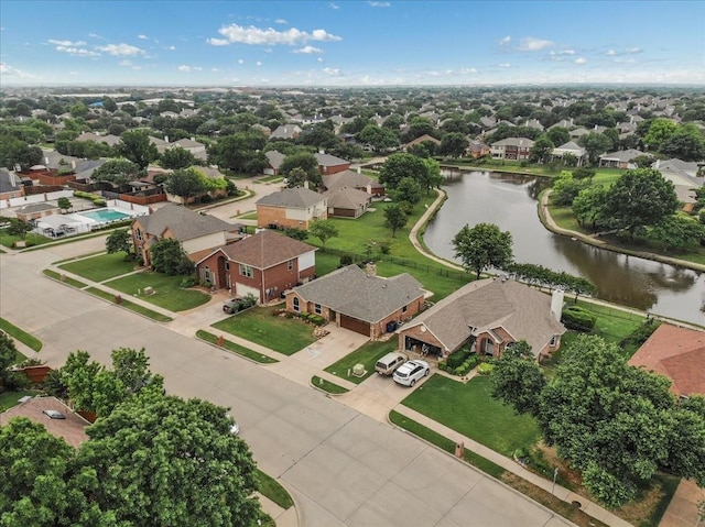 bird's eye view featuring a residential view and a water view