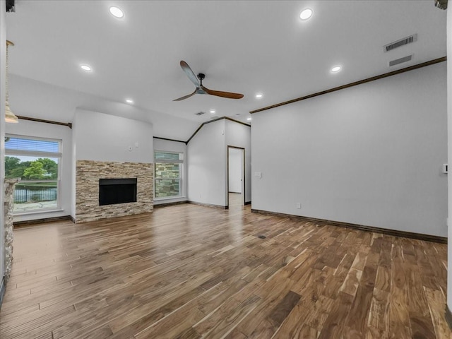 unfurnished living room with baseboards, a ceiling fan, wood finished floors, and visible vents