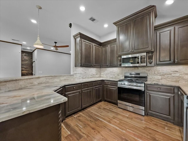 kitchen with visible vents, dark brown cabinetry, and stainless steel appliances