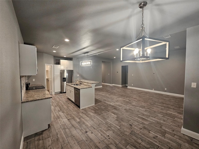 2120 Rw Bivens Ln, Fort Worth, TX 76105 - kitchen with stainless steel fridge with ice dispenser, dark wood-style flooring, white cabinets, a kitchen island with sink, and recessed lighting