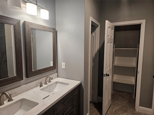 2120 Rw Bivens Ln, Fort Worth, TX 76105 - bathroom with double vanity, a closet, and a textured wall
