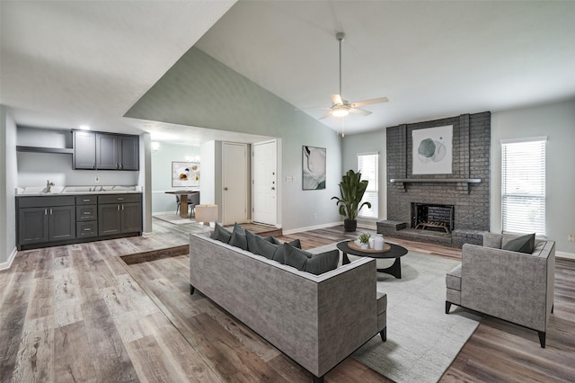 1200 Kesser Dr, Plano, TX 75025 - living room with baseboards, a fireplace, ceiling fan, and wood finished floors