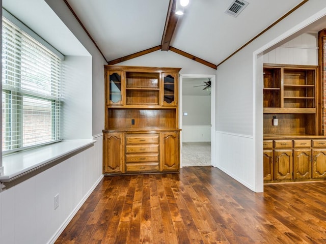 dining space with a ceiling fan, visible vents, wainscoting, lofted ceiling with beams, and dark wood-type flooring