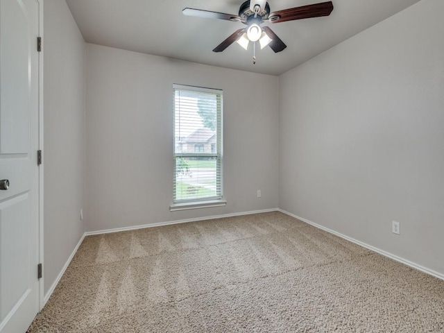 unfurnished room with baseboards, carpet flooring, and a ceiling fan