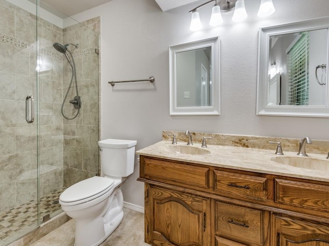 bathroom featuring double vanity, toilet, a sink, and a stall shower