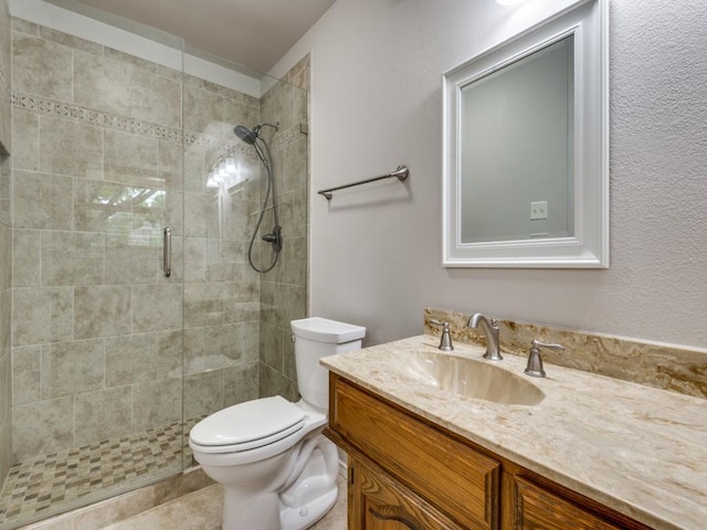 full bath featuring toilet, a shower stall, and vanity
