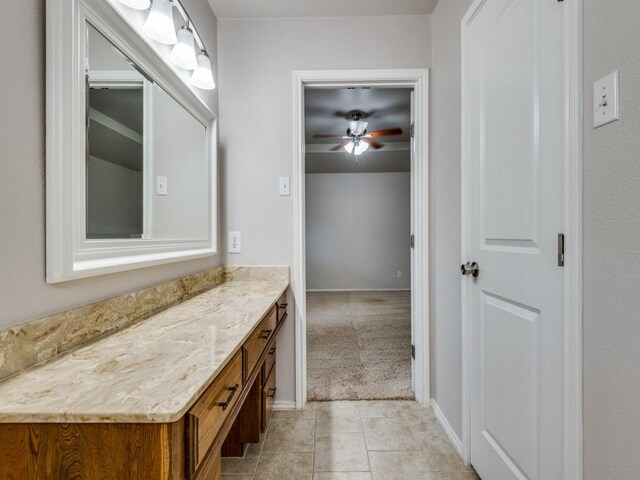 bathroom featuring vanity, tile patterned flooring, baseboards, and a ceiling fan