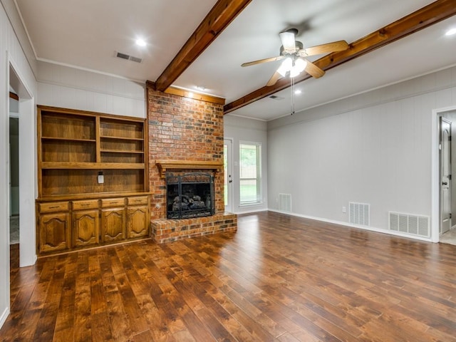 unfurnished living room with visible vents, a ceiling fan, dark wood-style flooring, and beam ceiling