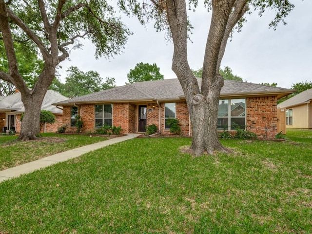 ranch-style home with brick siding and a front yard