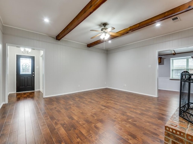 unfurnished living room with visible vents, beam ceiling, baseboards, dark wood-style floors, and ceiling fan with notable chandelier