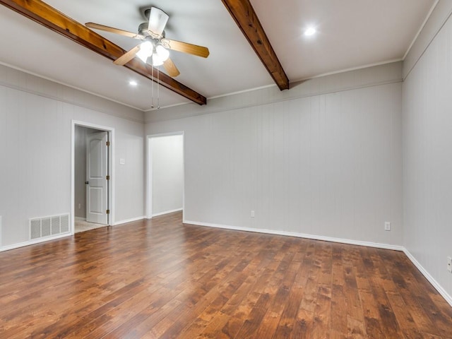 spare room featuring beam ceiling, wood-type flooring, a ceiling fan, baseboards, and visible vents