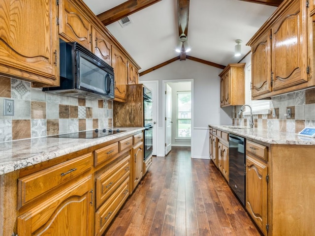 kitchen featuring lofted ceiling with beams, a sink, black appliances, and tasteful backsplash