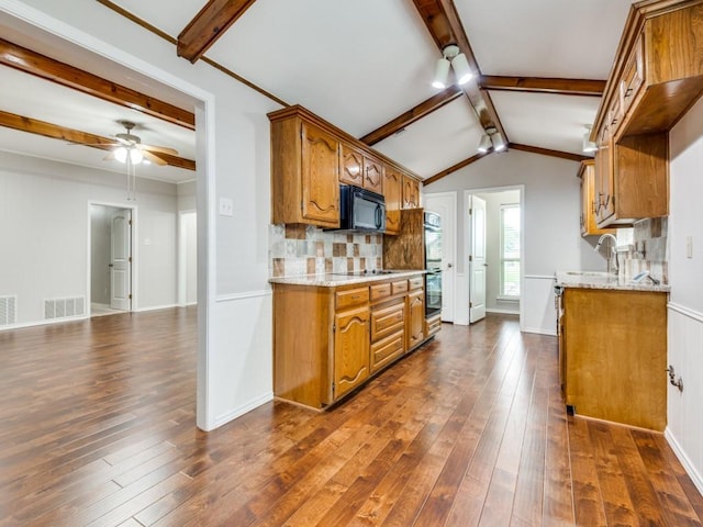 kitchen featuring black appliances, brown cabinets, dark wood-style floors, and visible vents