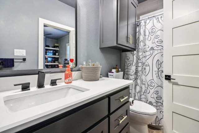 full bathroom with vanity, toilet, and curtained shower