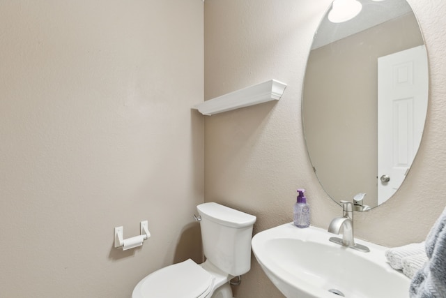 bathroom featuring toilet and a sink