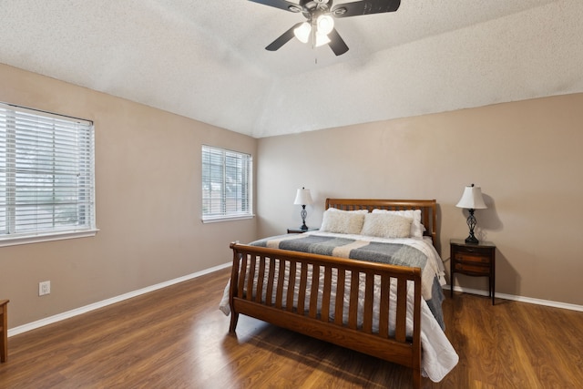 bedroom featuring baseboards, ceiling fan, vaulted ceiling, and wood finished floors