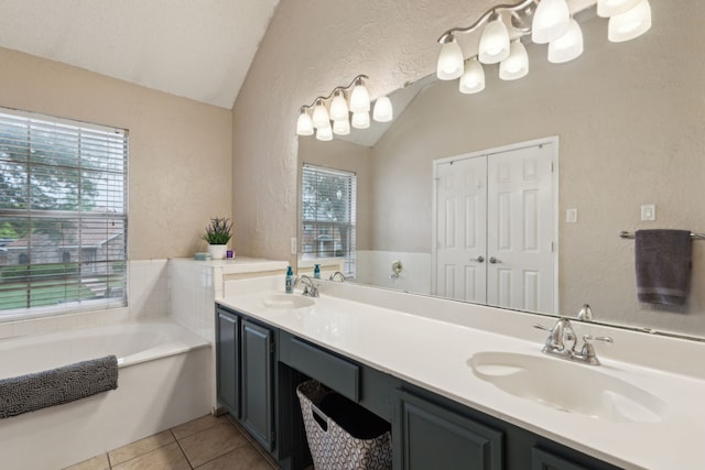 full bathroom with a sink, tile patterned flooring, a textured wall, and lofted ceiling