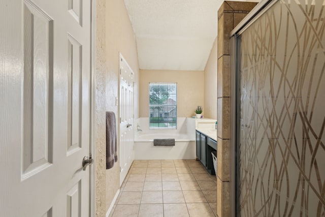 bathroom with vanity, a bath, tile patterned floors, a stall shower, and vaulted ceiling