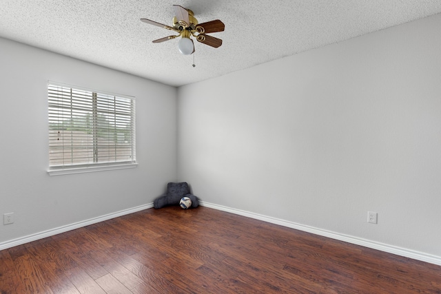 unfurnished room with a textured ceiling, ceiling fan, baseboards, and wood finished floors