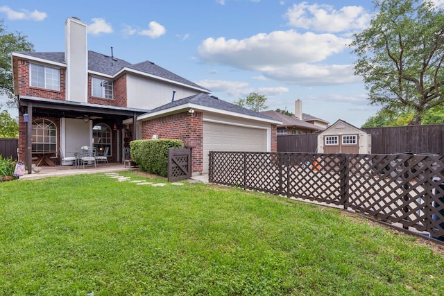 rear view of property featuring brick siding, an attached garage, fence, and a lawn