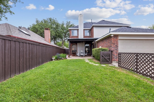 back of property featuring roof with shingles, brick siding, fence, a yard, and an attached garage