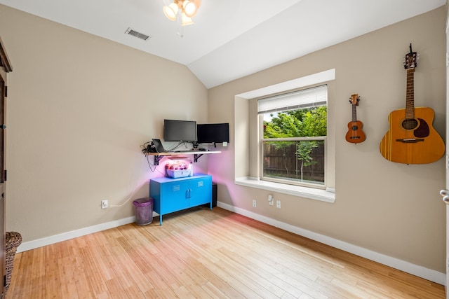 rec room featuring baseboards, visible vents, wood finished floors, and vaulted ceiling