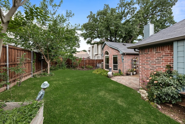 view of yard featuring a patio and a fenced backyard