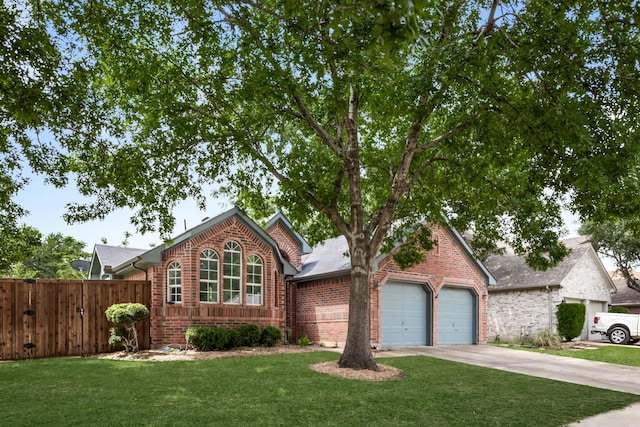 view of front of house featuring a garage, a front lawn, fence, brick siding, and driveway