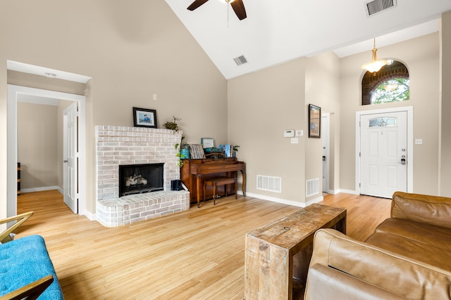 living area featuring high vaulted ceiling and visible vents