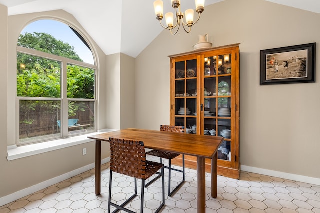 dining space with baseboards, a chandelier, and lofted ceiling