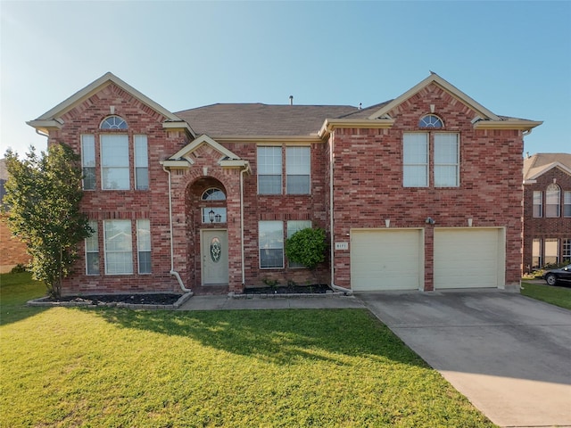 view of front of home with a garage, driveway, a front lawn, and brick siding