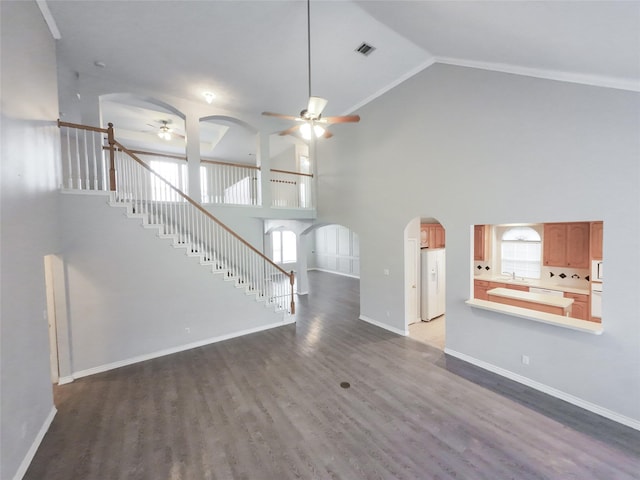 unfurnished living room featuring visible vents, wood finished floors, ceiling fan, high vaulted ceiling, and arched walkways