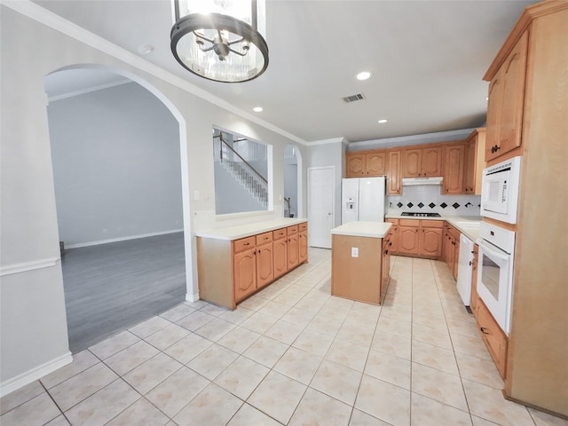 kitchen with visible vents, white appliances, light countertops, arched walkways, and light tile patterned floors