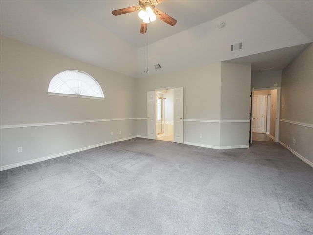 empty room featuring carpet flooring, a ceiling fan, baseboards, and visible vents
