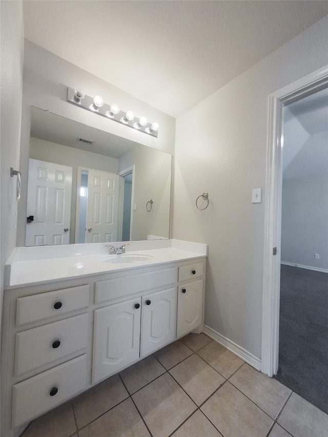 bathroom featuring vanity, baseboards, tile patterned floors, and visible vents