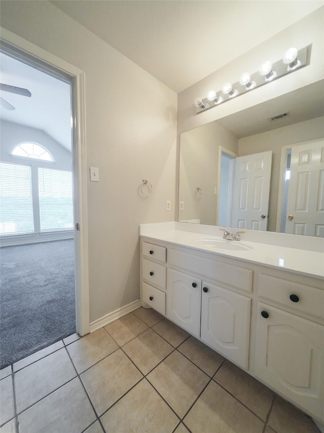 bathroom with visible vents, vanity, baseboards, ceiling fan, and tile patterned floors
