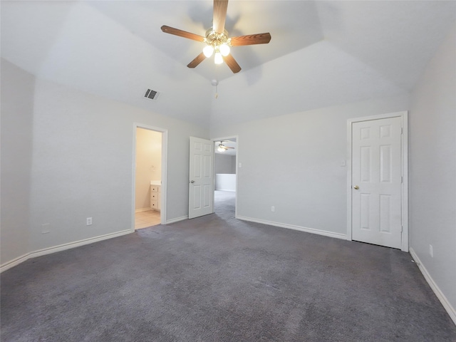 unfurnished bedroom featuring baseboards, dark carpet, and visible vents