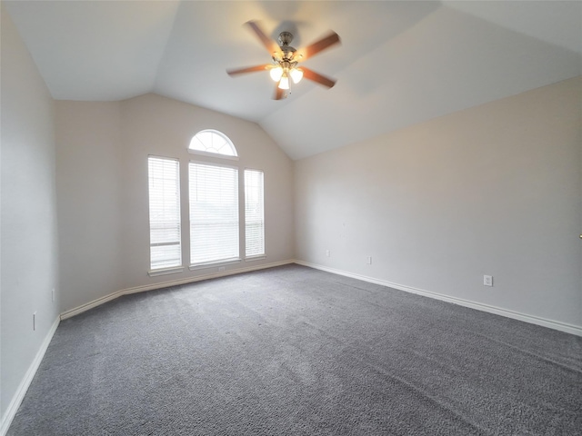 spare room with baseboards, ceiling fan, carpet flooring, and lofted ceiling