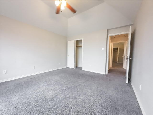 unfurnished bedroom featuring a ceiling fan, vaulted ceiling, baseboards, a closet, and dark carpet