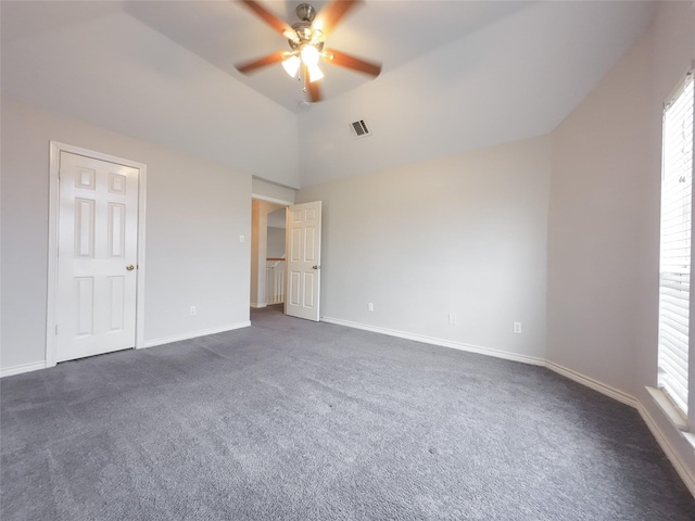 unfurnished bedroom with ceiling fan, high vaulted ceiling, dark colored carpet, baseboards, and visible vents