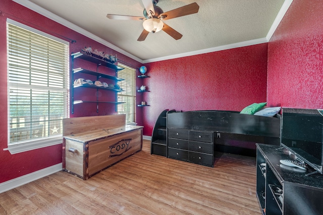 bedroom with ornamental molding, light wood finished floors, and multiple windows