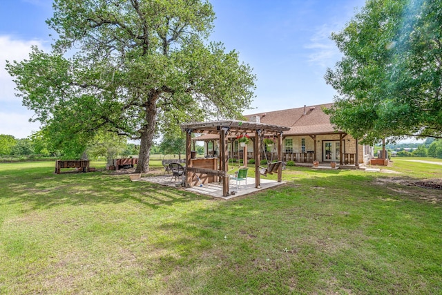 view of yard with french doors, a pergola, and a patio area